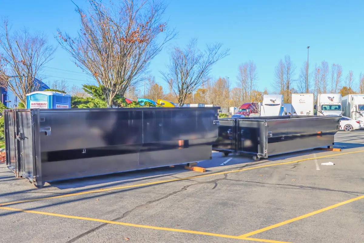 Professional dumpster rental service with roll-off container on residential driveway in Wakefield